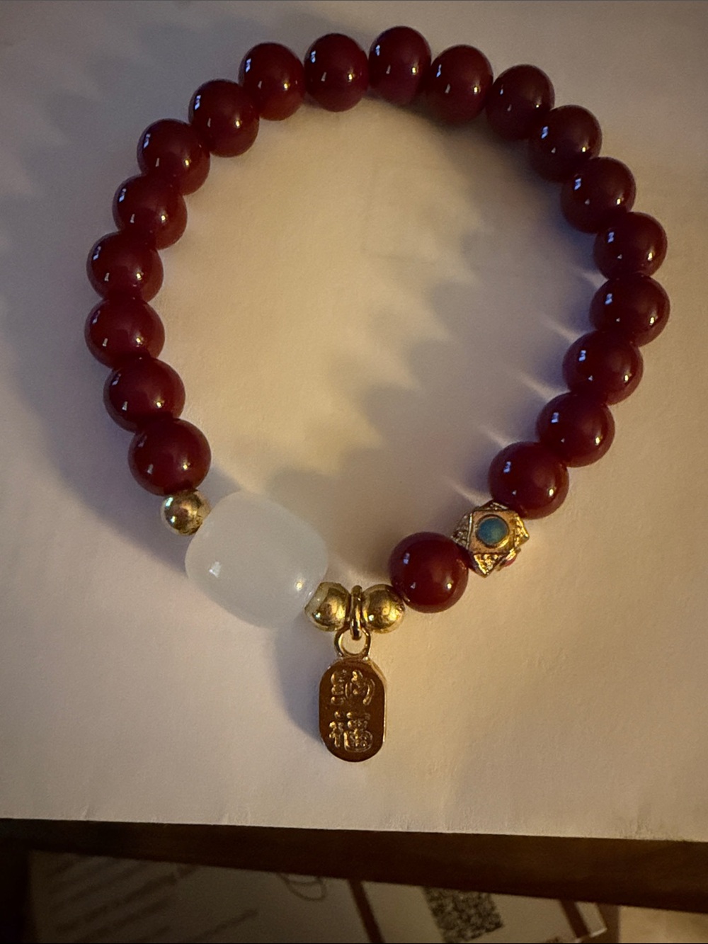 Red Bead Stretch Bracelet with White Accent and Gold Charm